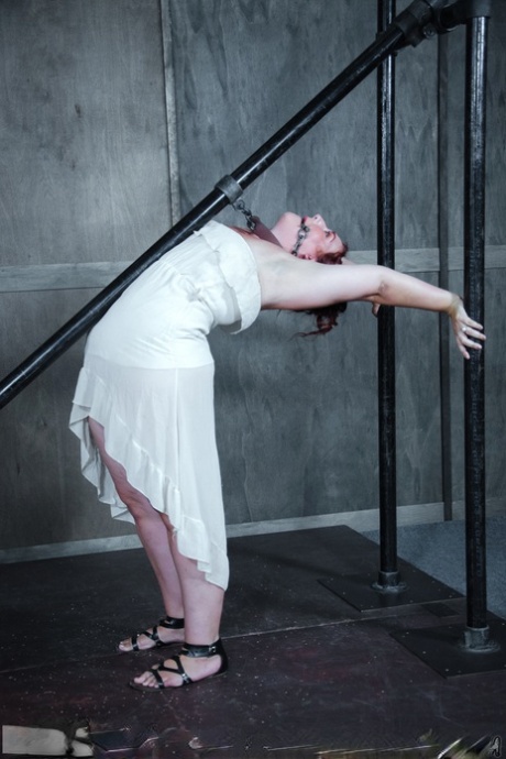 Overweight redhead Mimosa sports welts on her big ass in a dungeon