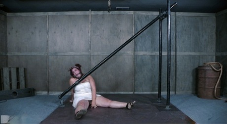 Overweight redhead Mimosa sports welts on her big ass in a dungeon