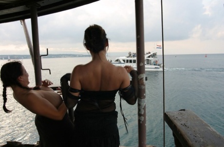 Lesbian women Kora Kryk & Aneta Buena flash their big boobs to a passing boat