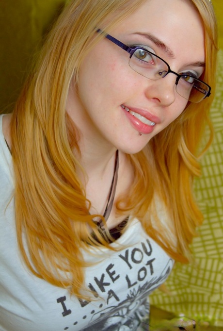Slender glasses clad Sue Connor peeling her jeans and displaying her big tits