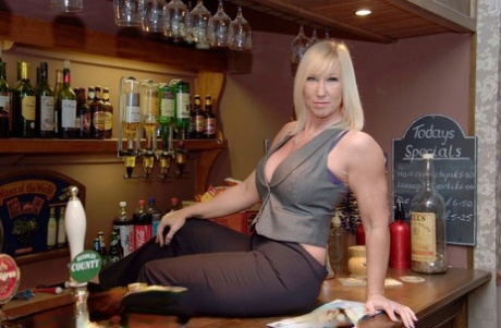 Blonde amateur Melody sets her large boobs loose inside a bar
