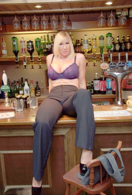 Blonde amateur Melody sets her large boobs loose inside a bar