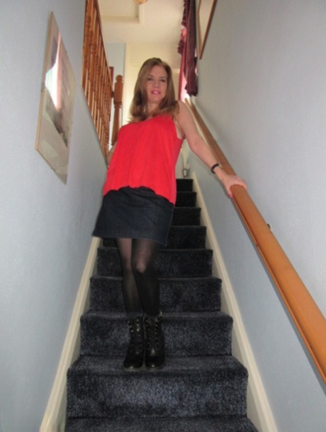 Foxy MILF Lily May displays her big booty and spreads pussy on the stairs