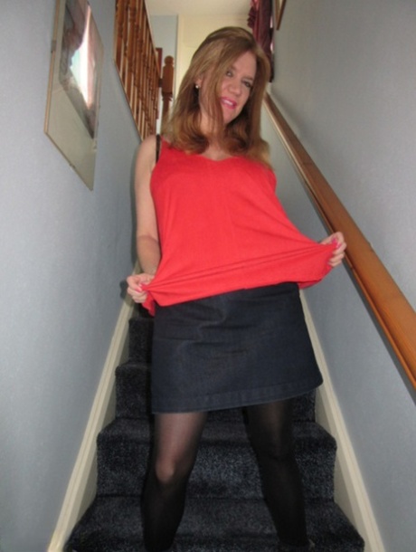 Foxy MILF Lily May displays her big booty and spreads pussy on the stairs