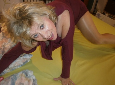 Busty mature woman Caro holds a cock after masturbating with sex toys