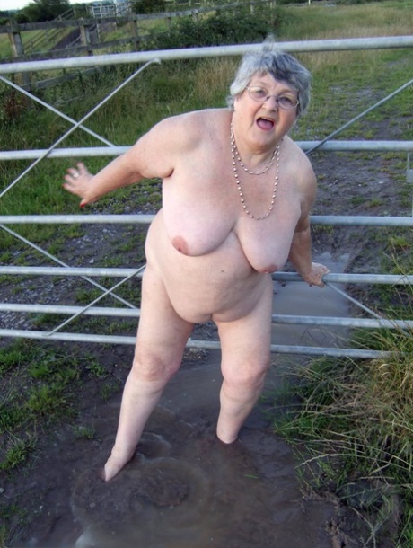 Fat nan Grandma Libby steps into a puddle before covering herself in mud