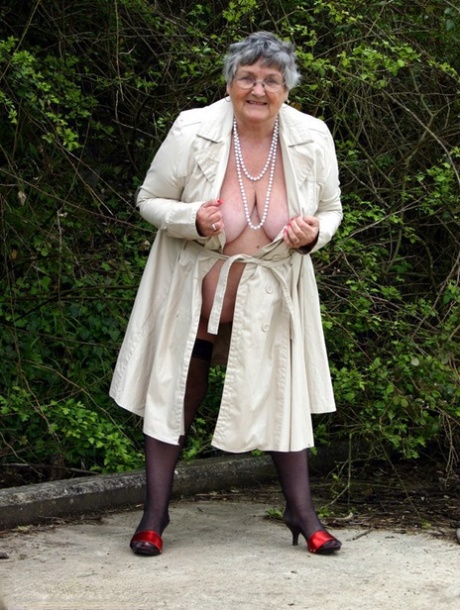 Fat nan Grandma Libby flashes by the trees in an overcoat before masturbating