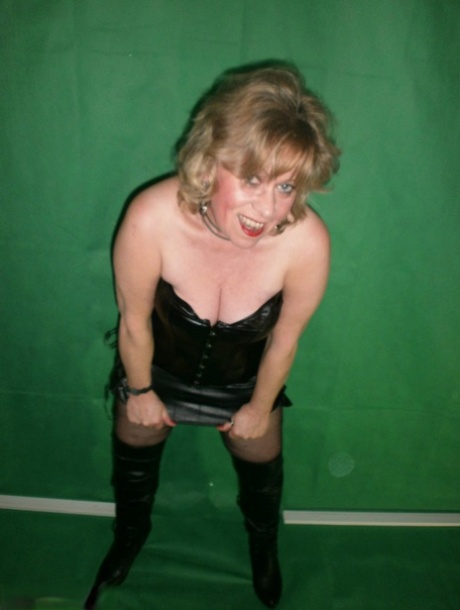 Mature blonde Caro fingers her snatch in ripped hose and leather apparel