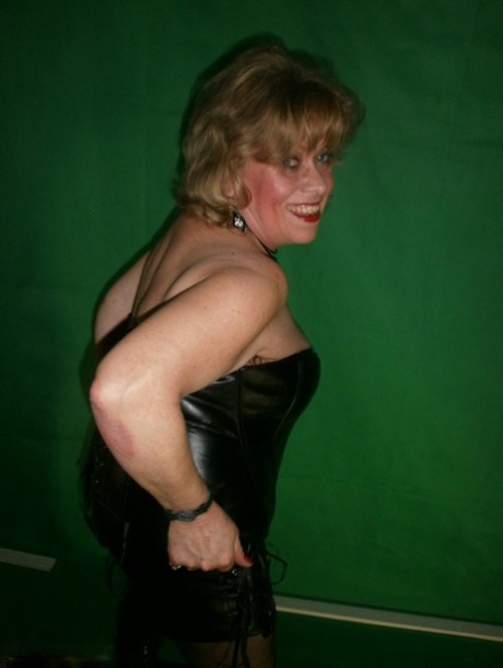 Mature blonde Caro fingers her snatch in ripped hose and leather apparel
