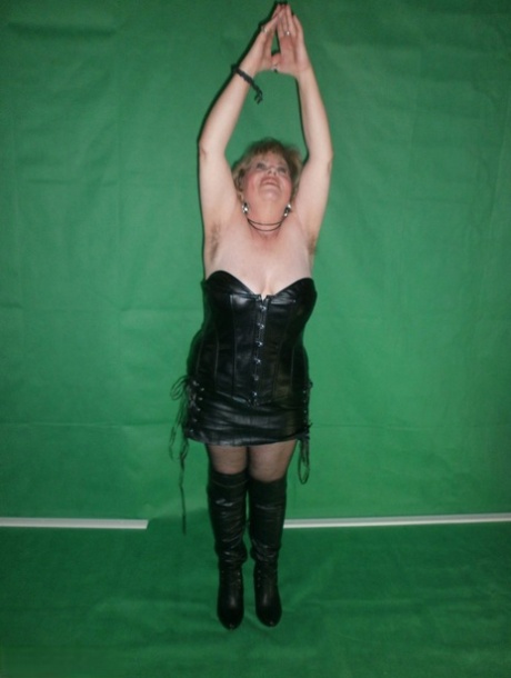 Mature blonde Caro fingers her snatch in ripped hose and leather apparel
