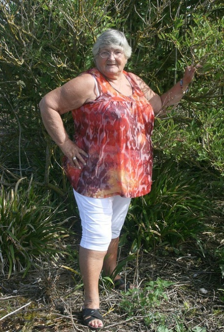 Obese nan Grandma Libby strips totally naked out by evergreen trees