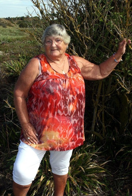 Obese nan Grandma Libby strips totally naked out by evergreen trees