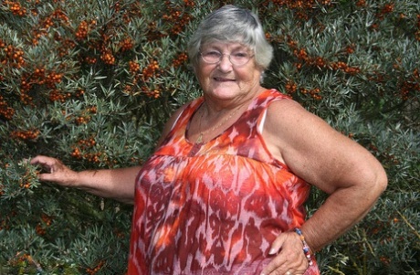 Obese nan Grandma Libby strips totally naked out by evergreen trees