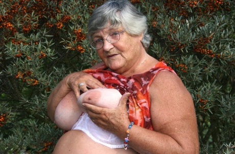 Obese nan Grandma Libby strips totally naked out by evergreen trees