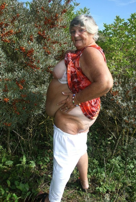 Obese nan Grandma Libby strips totally naked out by evergreen trees