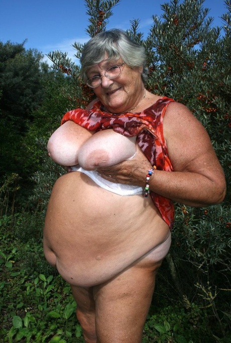 Obese nan Grandma Libby strips totally naked out by evergreen trees