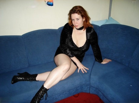 Natural redhead disrobes for a finger fuck in hosiery and granny boots