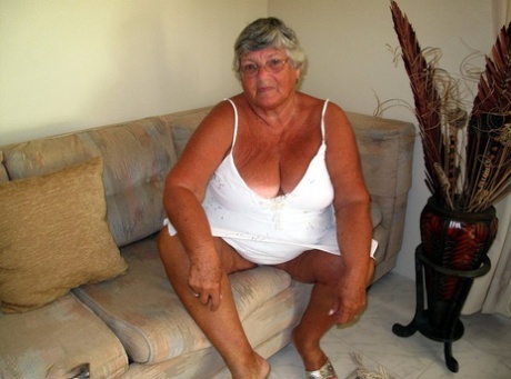 Fat lady Grandma Libby bares her saggy tits and big ass while on a couch
