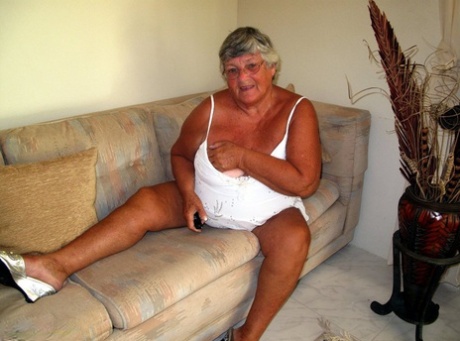 Fat lady Grandma Libby bares her saggy tits and big ass while on a couch