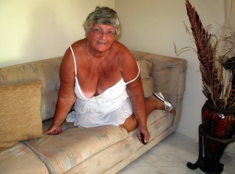 Fat lady Grandma Libby bares her saggy tits and big ass while on a couch