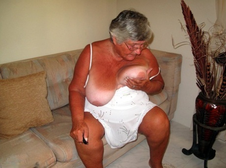 Fat lady Grandma Libby bares her saggy tits and big ass while on a couch