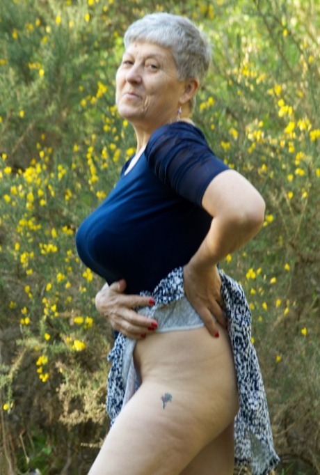 Naughty granny Savana reveals her big juggs and juicy ass in public