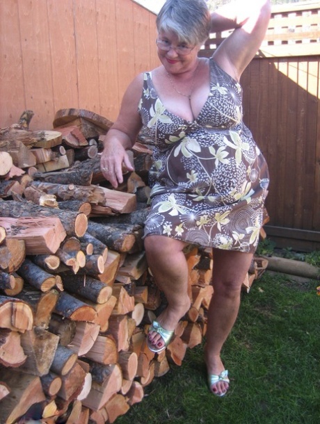 Brazen older granny strips off by the wood pile to show off BBW tits & big ass