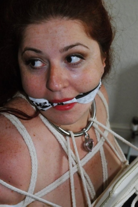 Fat female with red lisp is left gagged and tied up by ropes