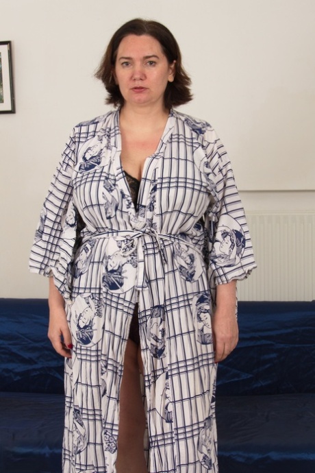 Thick older woman removes robe and lingerie before riding her lover's penis