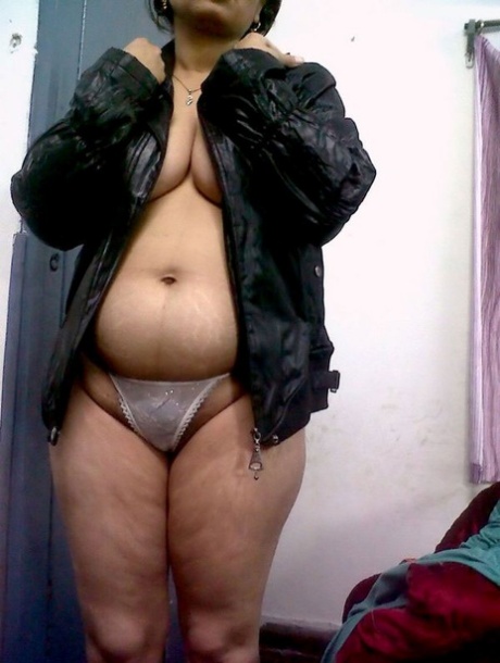Fat Indian woman hides her face while adorned in a bra and thong