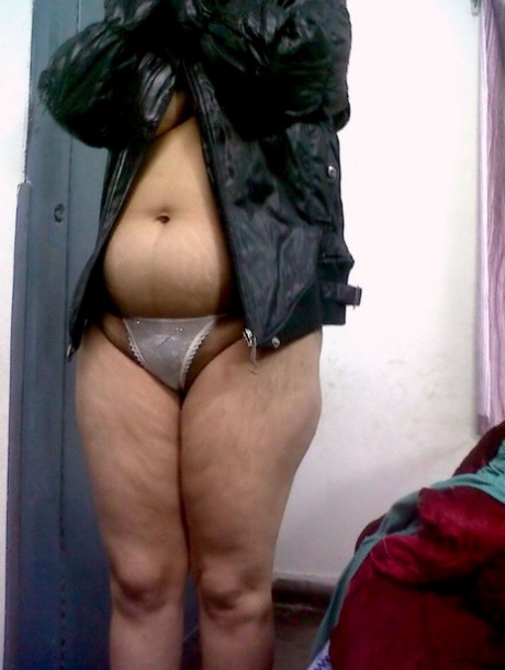 Fat Indian woman hides her face while adorned in a bra and thong