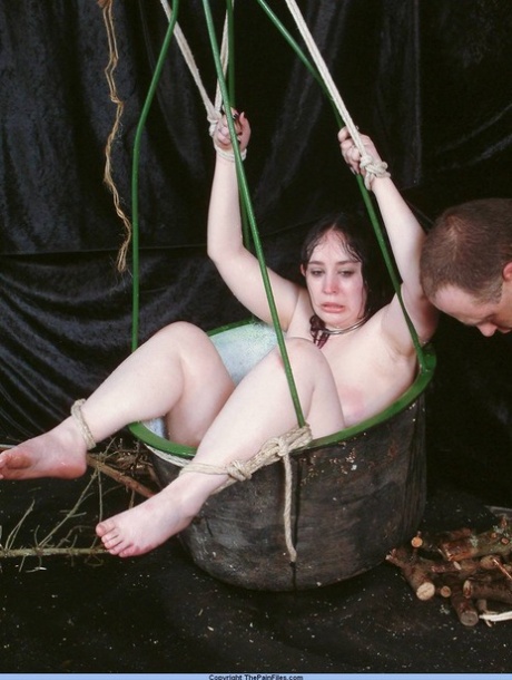 Overweight female sex slave is restrained in a basket during needle play