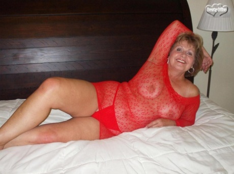 Older amateur Busty Bliss kisses a tiny cock after posing in see thru lingerie