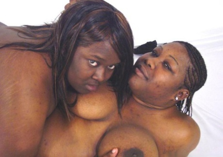 Fat black lesbians show their big natural tits while wrestling each other