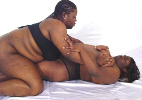 Fat black lesbians show their big natural tits while wrestling each other