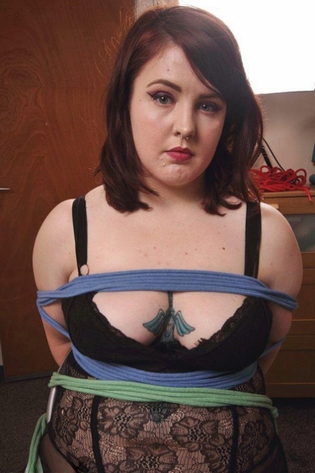 Tattooed plumper is silenced with a cleave gag while tied to a folding chair