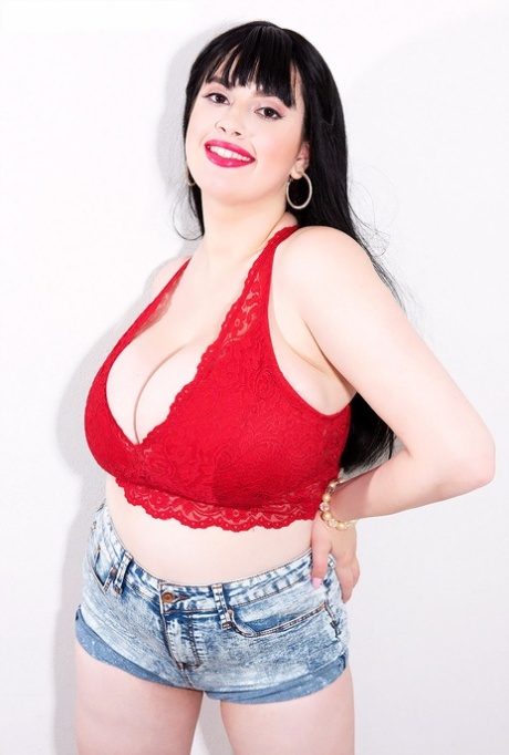Dark-haired girl Dina Sahari sports red lips while unleashing her knockers