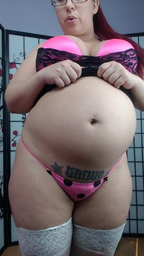 Preggo slut Peaches in white stockings on her knees showing her big ass