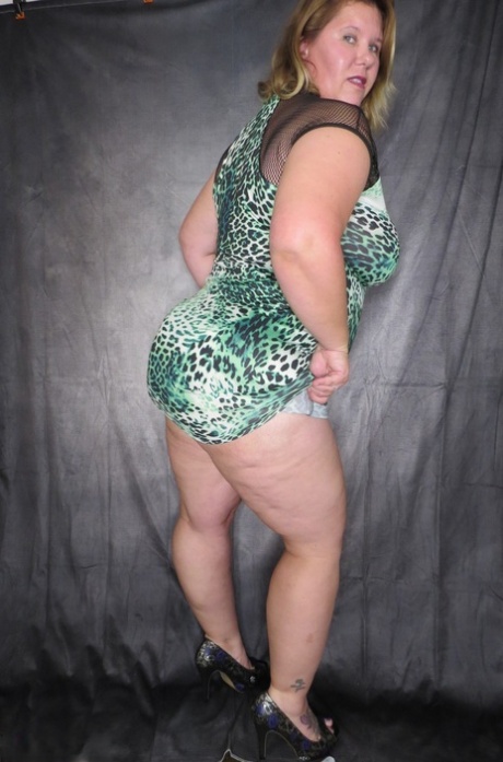 Obese amateur Busty Kris Ann takes of a dress and thong to model naked