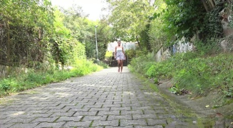 Distressed girl Chloe Lamour takes a piss on a cobblestone walkway