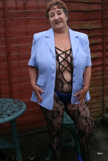 Fat older woman Kinky Carol releases her huge tits from a body stocking