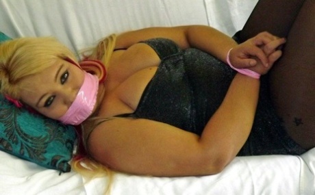 Blonde fatty is gagged with her wrists and ankles tied up