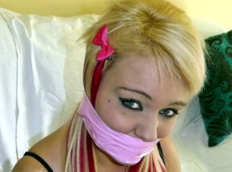 Blonde fatty is gagged with her wrists and ankles tied up