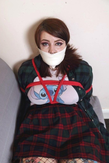 Chubby girl has her mouth covered up while restrained in quarantine