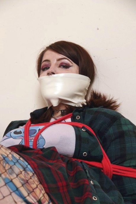 Chubby girl has her mouth covered up while restrained in quarantine