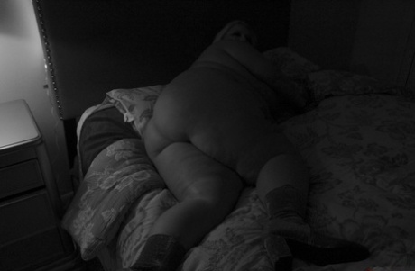 Obese blonde amateur shows her huge ass on a bed in a v-shape bikini