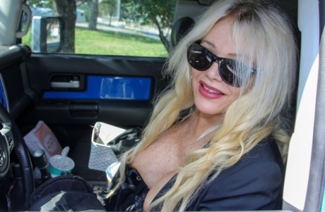 Hot blonde granny Allissa West masturbates with a toy while wearing stockings