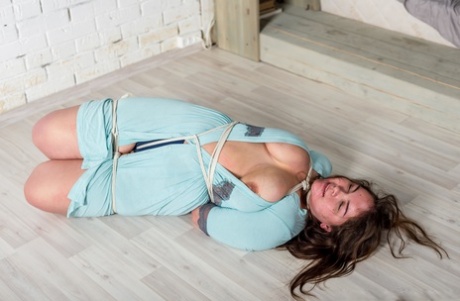 Overweight girl Natasha is left gagged and tied up while barefoot in a dress