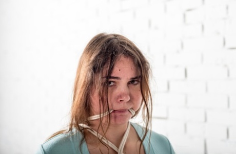 Overweight girl Natasha is left gagged and tied up while barefoot in a dress