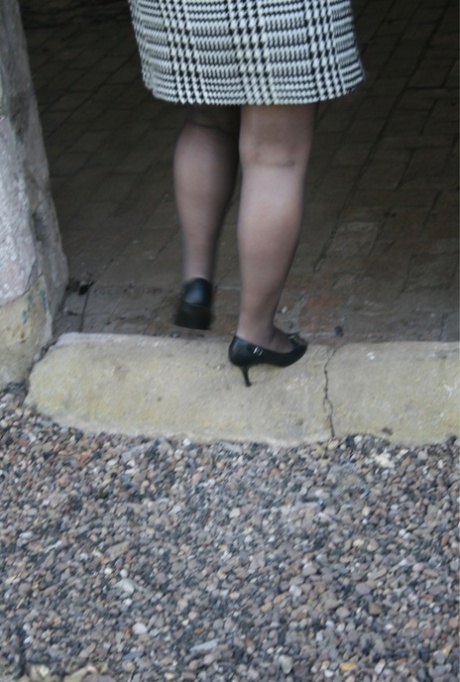 Mature BBW Kinky Carol strips to her lingerie and stockings in an old dwelling